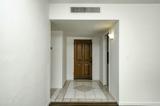 hall with light tile patterned flooring