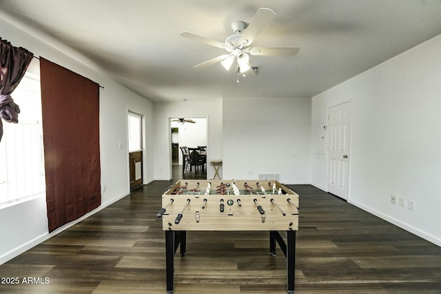 playroom with ceiling fan, dark hardwood / wood-style flooring, and a wealth of natural light