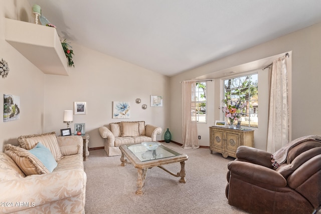 carpeted living room featuring lofted ceiling