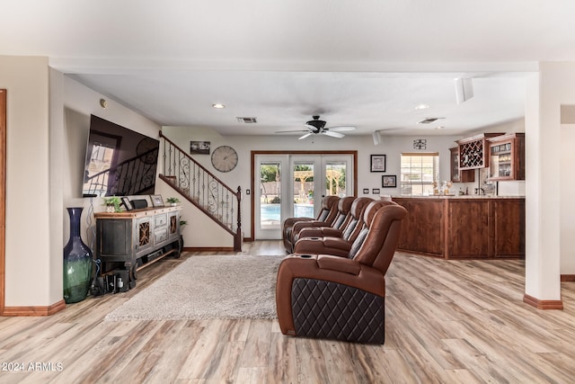 living room with ceiling fan, light hardwood / wood-style flooring, and french doors