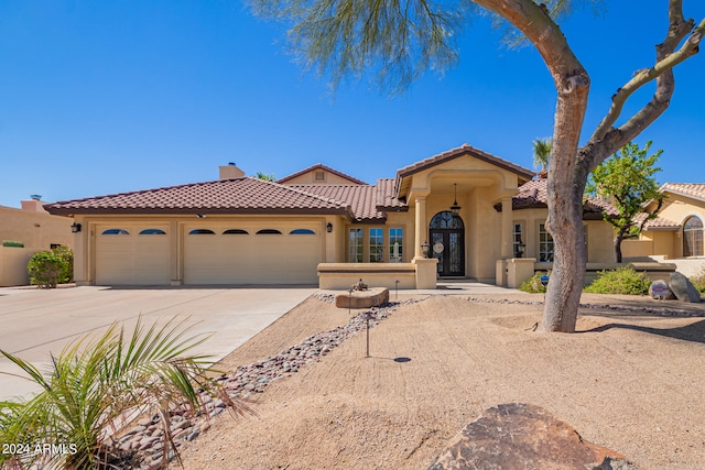 mediterranean / spanish house featuring a garage