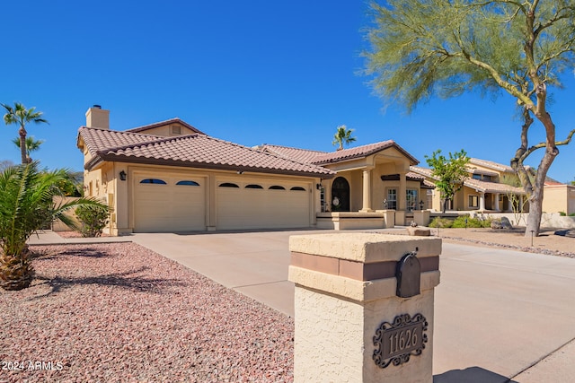 mediterranean / spanish-style home featuring a garage