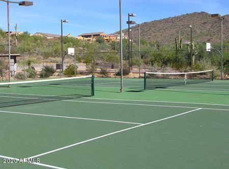 view of tennis court with a mountain view