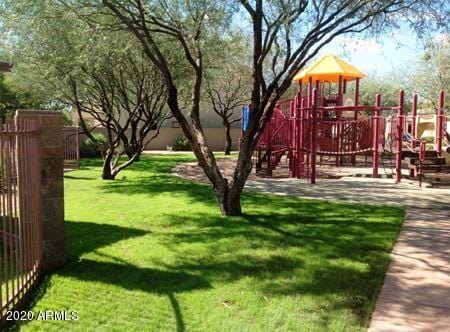 view of playground with a lawn