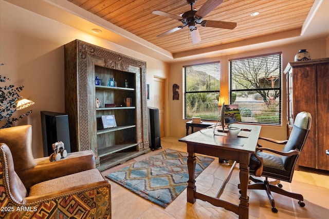 office space with wooden ceiling, built in shelves, a raised ceiling, and ceiling fan