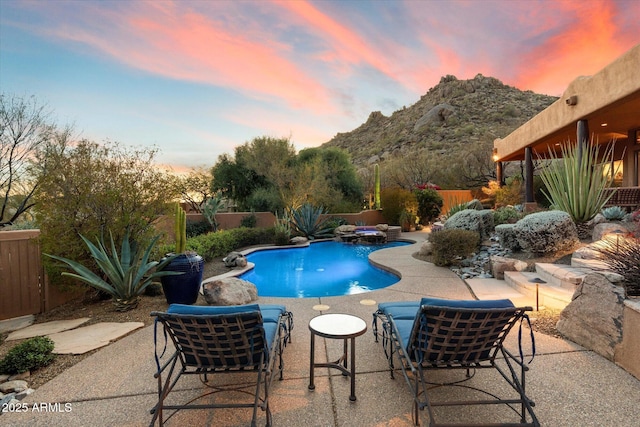 view of swimming pool with an in ground hot tub, a patio area, a mountain view, and a fenced backyard