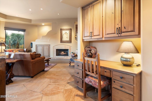 office area featuring recessed lighting and a lit fireplace