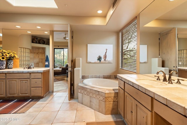 full bathroom with a sink, a garden tub, two vanities, and tile patterned floors