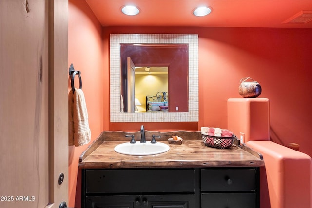 bathroom with vanity, recessed lighting, and visible vents