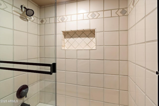 bathroom with tiled shower