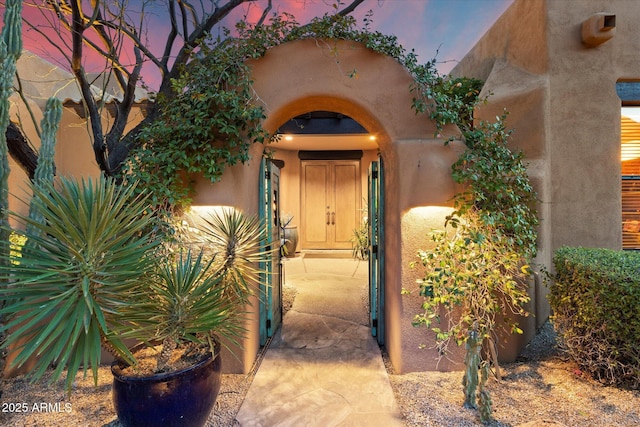 doorway to property with stucco siding