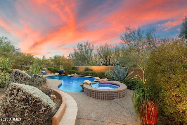 view of pool featuring a patio area and a pool with connected hot tub