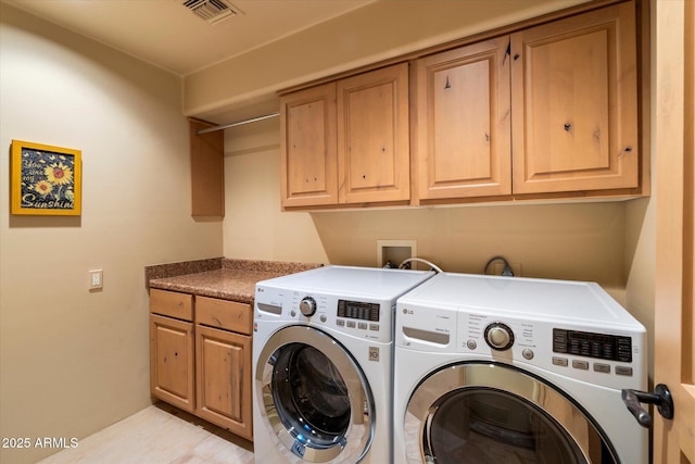 laundry room with cabinet space, visible vents, and washer and dryer