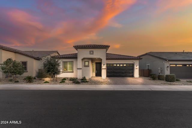 mediterranean / spanish home featuring a garage