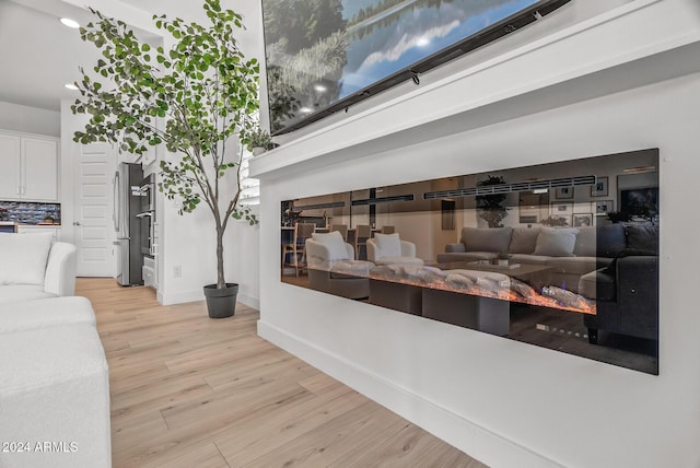 room details with wood-type flooring and stainless steel refrigerator