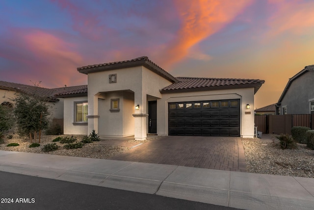 mediterranean / spanish-style home with a garage