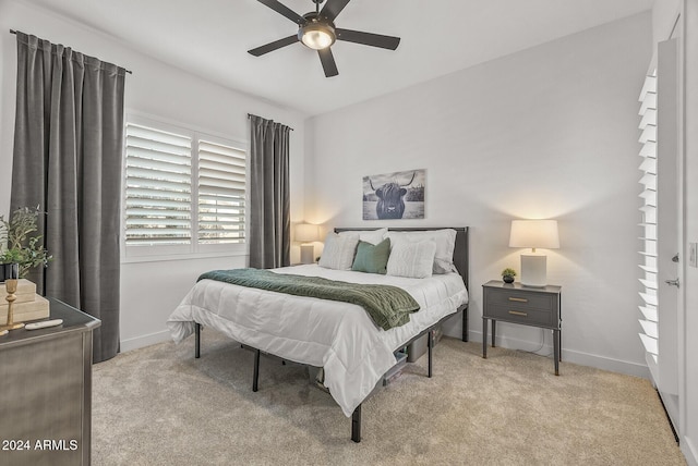 bedroom featuring light colored carpet and ceiling fan