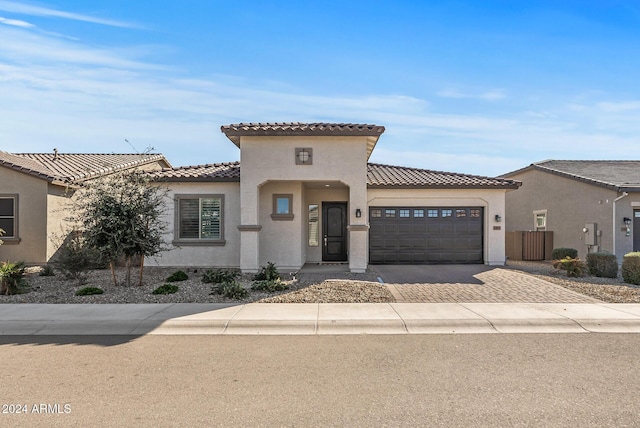 mediterranean / spanish house with a garage