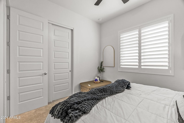 bedroom with ceiling fan, a closet, and carpet floors