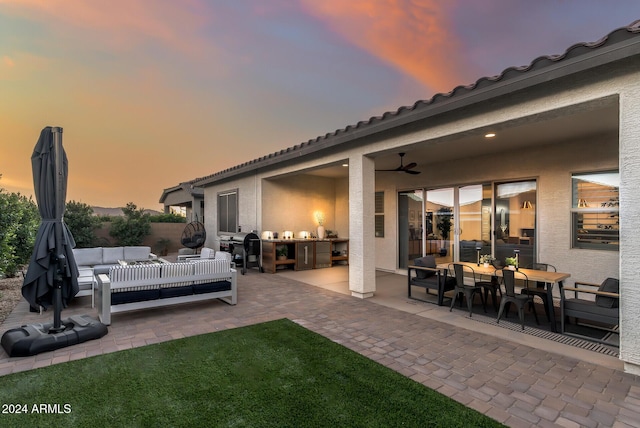 patio terrace at dusk featuring an outdoor living space