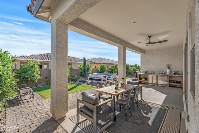 view of patio / terrace featuring ceiling fan, an outdoor kitchen, and an outdoor hangout area