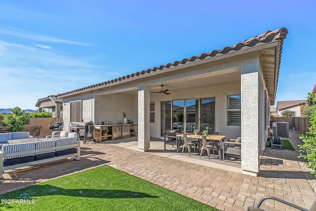 back of house featuring outdoor lounge area, ceiling fan, a yard, cooling unit, and a patio area