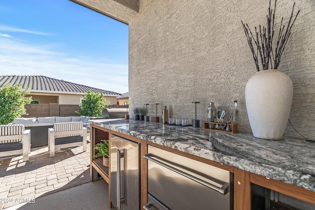 view of patio with wine cooler