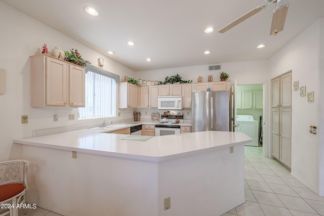 kitchen with light brown cabinetry, white appliances, kitchen peninsula, light tile patterned flooring, and ceiling fan