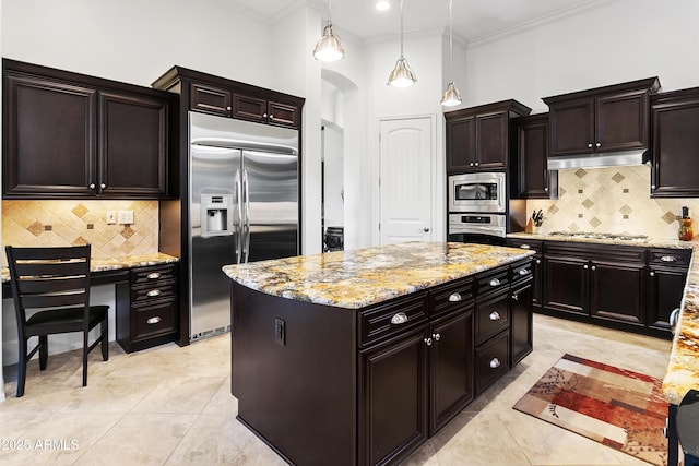 kitchen with built in appliances, a center island, pendant lighting, and ornamental molding