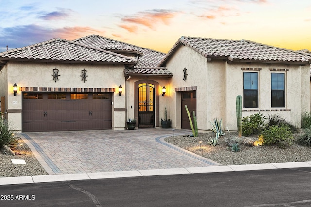 mediterranean / spanish-style home with a garage