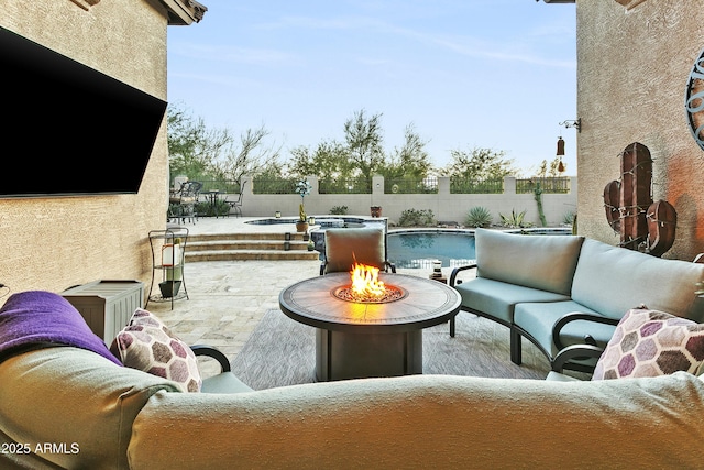 view of patio with a fenced in pool and an outdoor living space with a fire pit