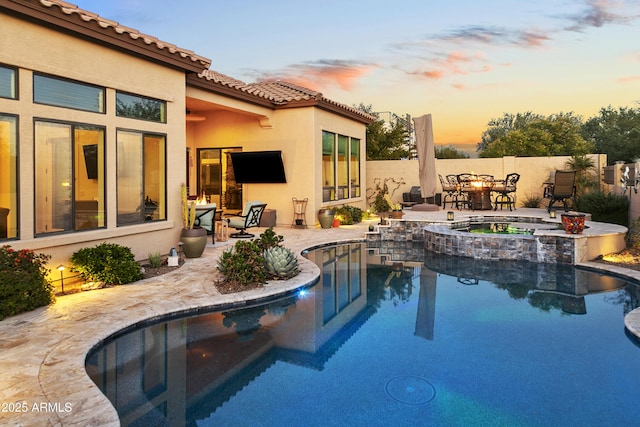 view of pool with an in ground hot tub and a patio