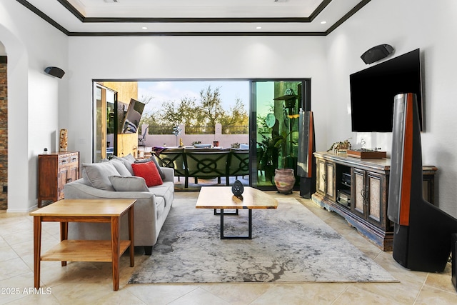 tiled living room with a towering ceiling and ornamental molding