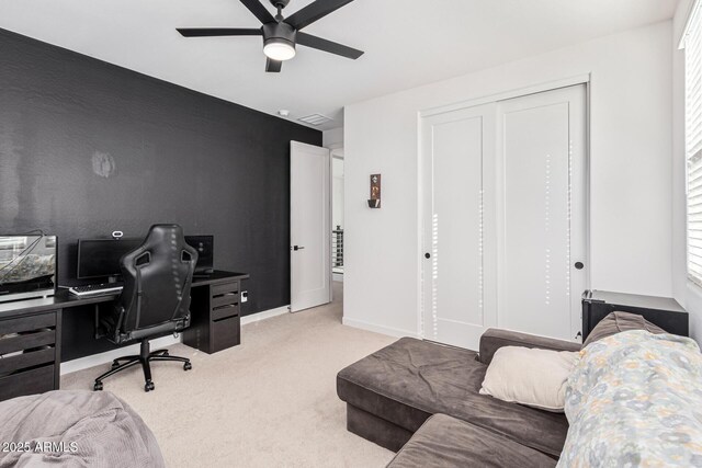 home office featuring ceiling fan and light colored carpet