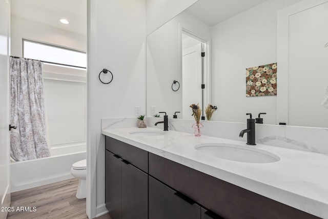 full bathroom with shower / tub combo, vanity, toilet, and wood-type flooring