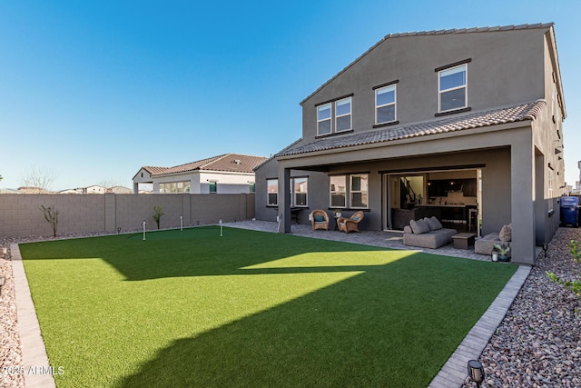 rear view of property featuring a patio area and outdoor lounge area