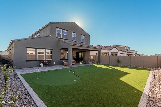 back of house with a patio area and an outdoor living space