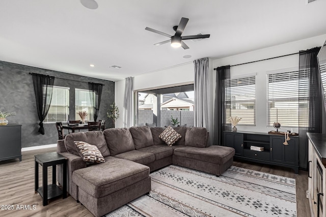 living room with ceiling fan and hardwood / wood-style floors