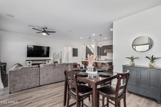 dining space with ceiling fan and light hardwood / wood-style floors