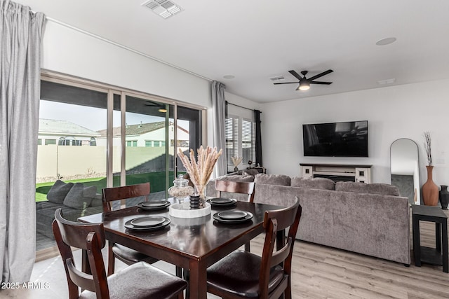 dining room with light hardwood / wood-style flooring and ceiling fan