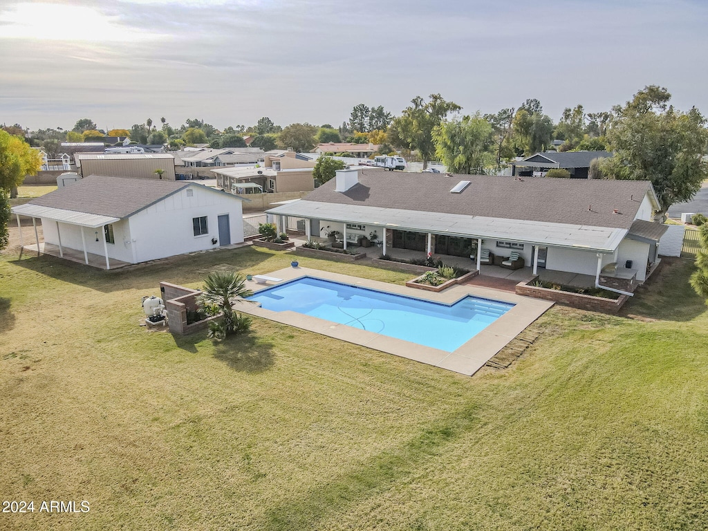 view of swimming pool featuring a patio and a lawn