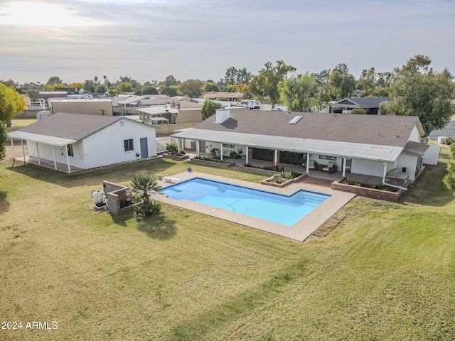 view of swimming pool featuring a patio and a lawn