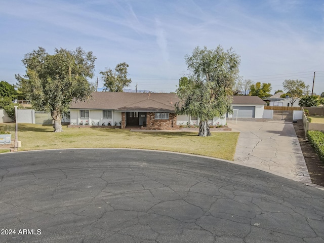 ranch-style home with a front yard and a garage