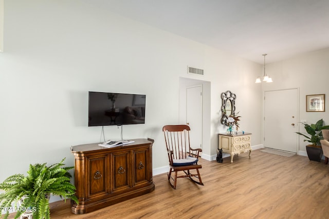 living area featuring a chandelier and light wood-type flooring