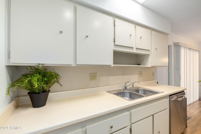 kitchen featuring sink, white cabinets, light wood-type flooring, and stainless steel dishwasher