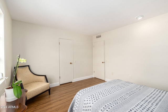 bedroom with hardwood / wood-style flooring