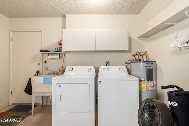 laundry room with a textured ceiling, washer and clothes dryer, and electric water heater