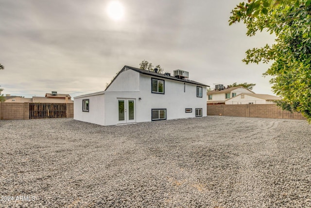 rear view of property featuring french doors and central AC