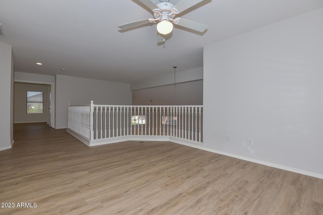 empty room featuring ceiling fan and light hardwood / wood-style flooring