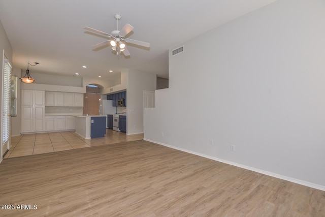 unfurnished living room featuring ceiling fan and light wood-type flooring